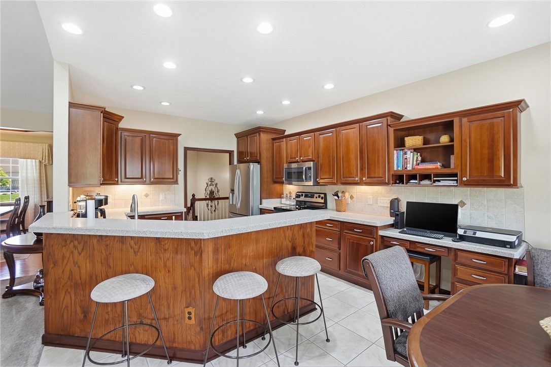 710 Governors Road Troy, OH 45373 - Photo 10 of 56 This spacious kitchen offers a large island with seating, ample storage, and functional work areas.