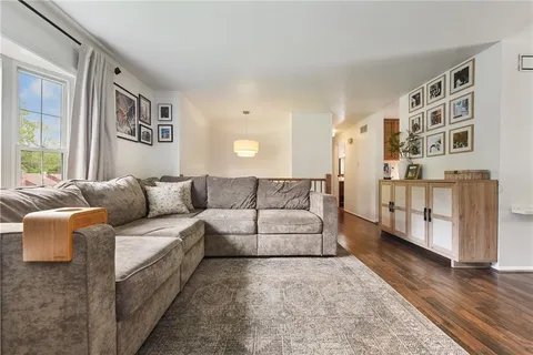 a living room with furniture and a book shelf