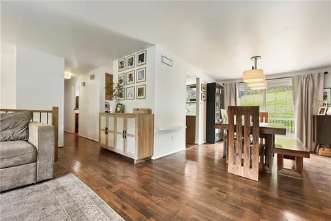 a view of a livingroom with furniture and wooden floor