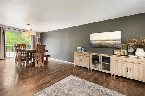 a view of a dining room with furniture and wooden floor