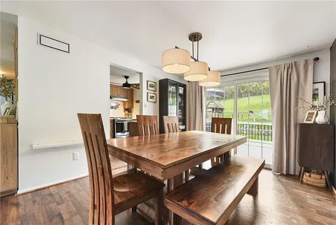a view of a dining room with furniture window and wooden floor