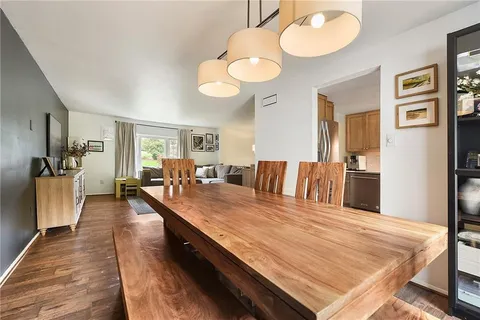 a living room with stainless steel appliances granite countertop furniture a fireplace and a large window