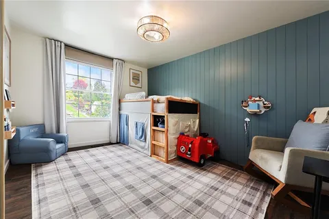 a bedroom with furniture and a window