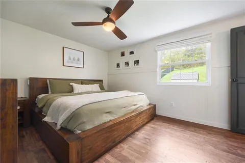 a bedroom with a bed and a large window