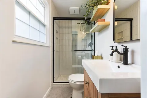 a bathroom with a sink toilet and shower