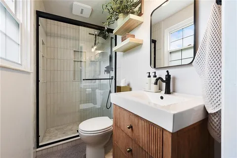 a bathroom with a sink toilet and shower