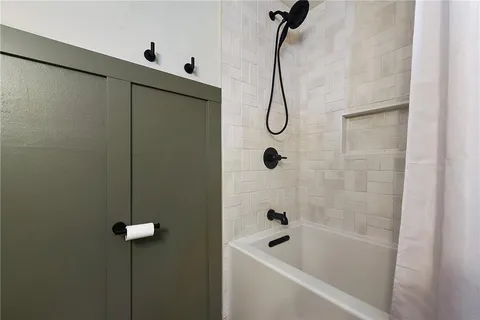a bathroom with a shower and a bathtub