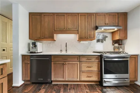 a kitchen with granite countertop a stove and a sink