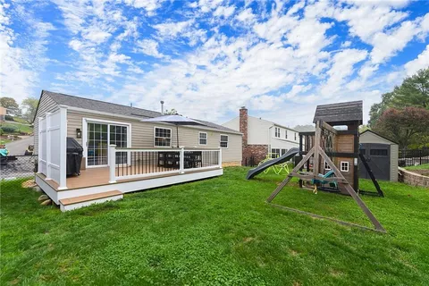 a view of a house with a backyard