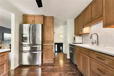 a kitchen with stainless steel appliances a refrigerator sink and cabinets