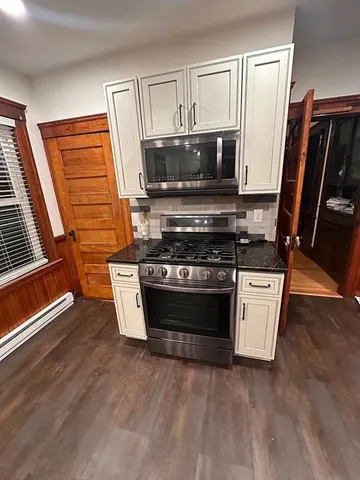 a view of kitchen appliances and wooden floor