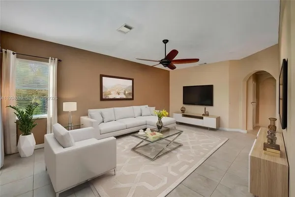 a kitchen with stainless steel appliances kitchen island granite countertop a stove refrigerator and cabinets