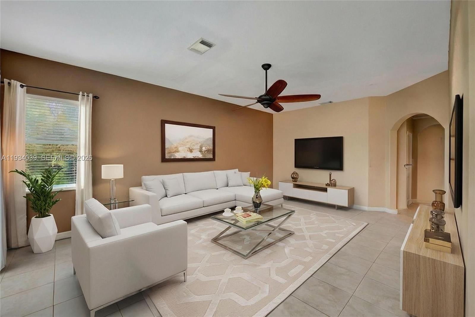 5337 Southwest 131st Terrace Miramar, FL 33027 - Photo 12 of 46 a living room with furniture and a flat screen tv