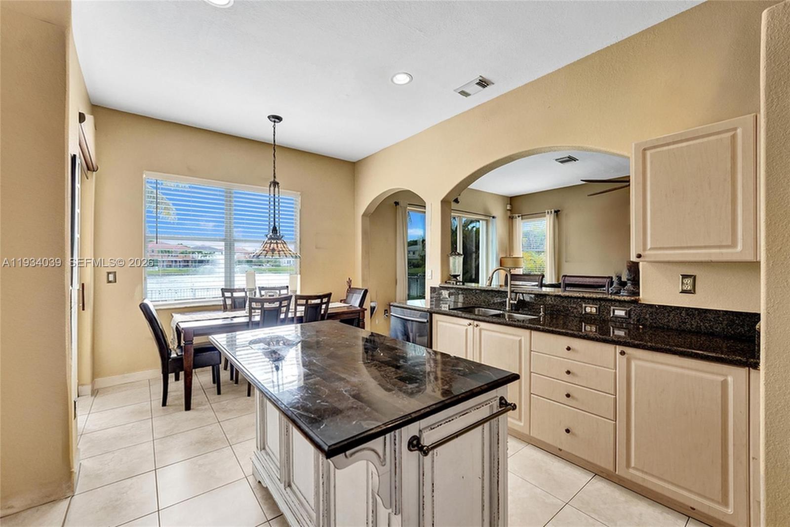5337 Southwest 131st Terrace Miramar, FL 33027 - Photo 14 of 46 a kitchen with granite countertop a sink and cabinets