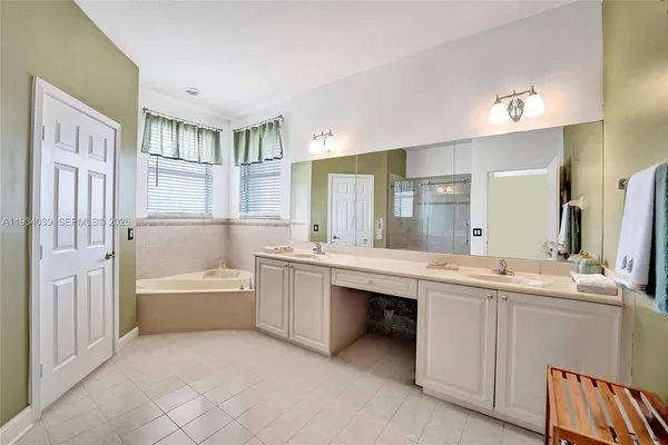 a en suite bathroom with a tub shower and window