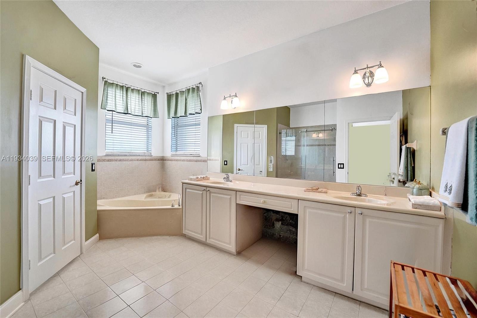 5337 Southwest 131st Terrace Miramar, FL 33027 - Photo 19 of 46 a bathroom with a tub a sink and a mirror