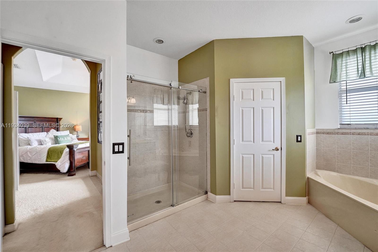 5337 Southwest 131st Terrace Miramar, FL 33027 - Photo 20 of 46 a en suite bathroom with a tub shower and window