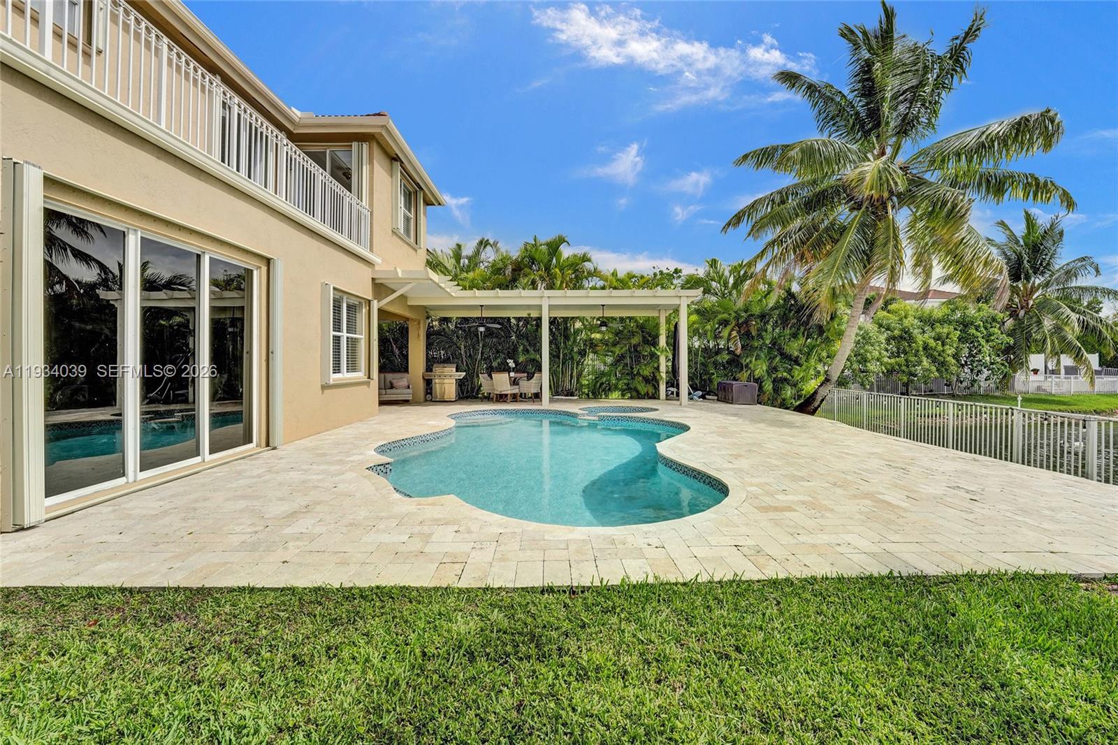 5337 Southwest 131st Terrace Miramar, FL 33027 - Photo 36 of 46 a view of a house with a swimming pool and a yard