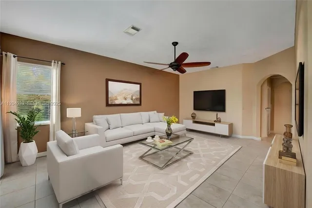 a living room with furniture and a flat screen tv