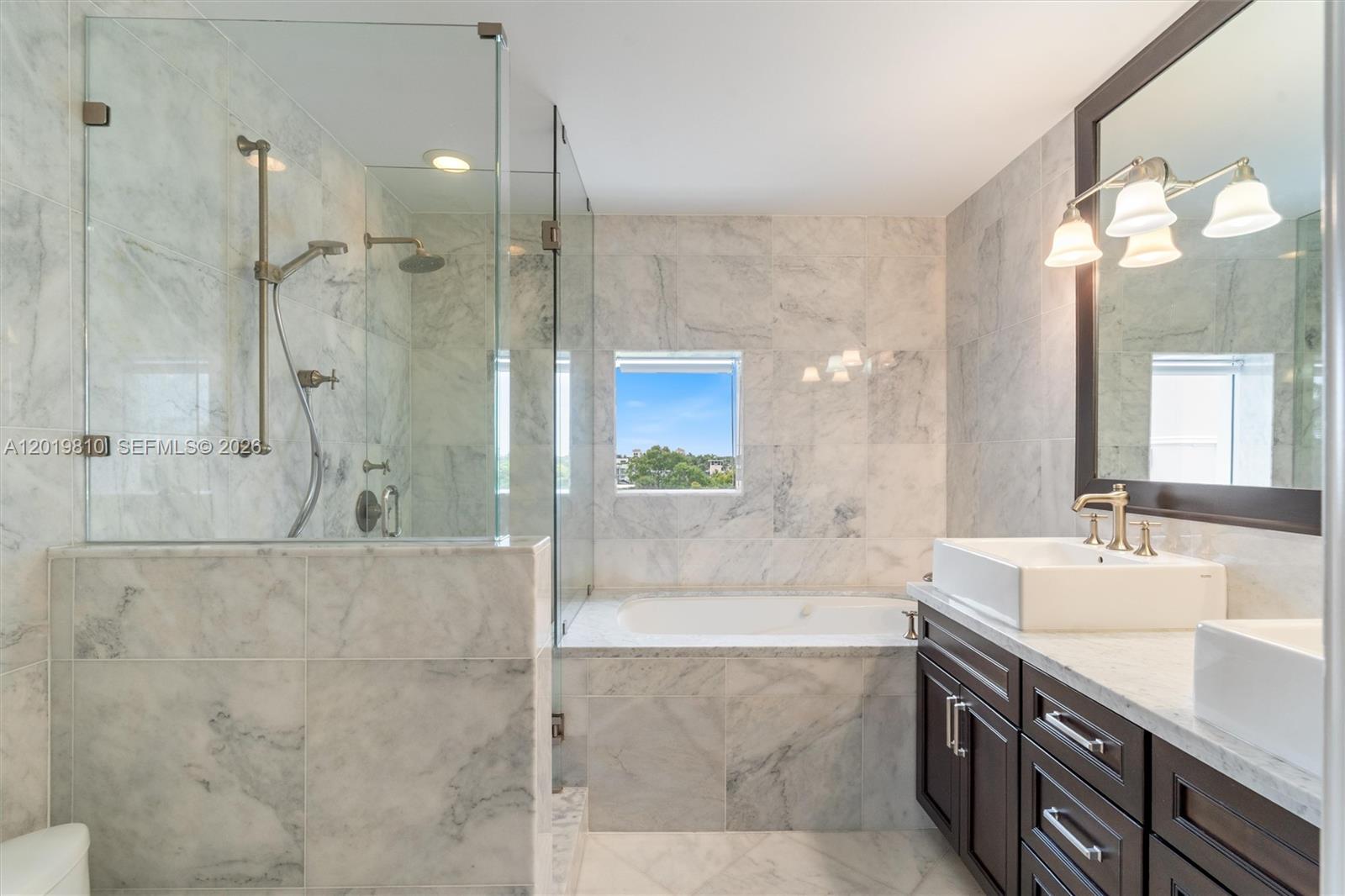 455 East Palmetto Park Road, Unit 4E Boca Raton, FL 33432 - Photo 15 of 30 a bathroom with a double vanity sink mirror and shower