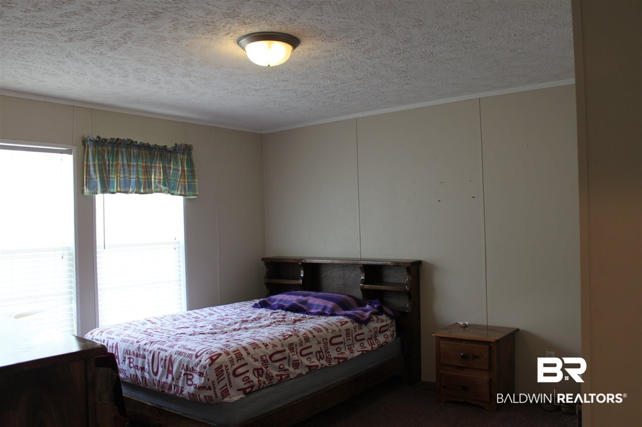 9380 Spice Pond Road Eight Mile, AL 36613 - Photo 32 of 36 Sunny large bedroom w/attached J-n-J bath.