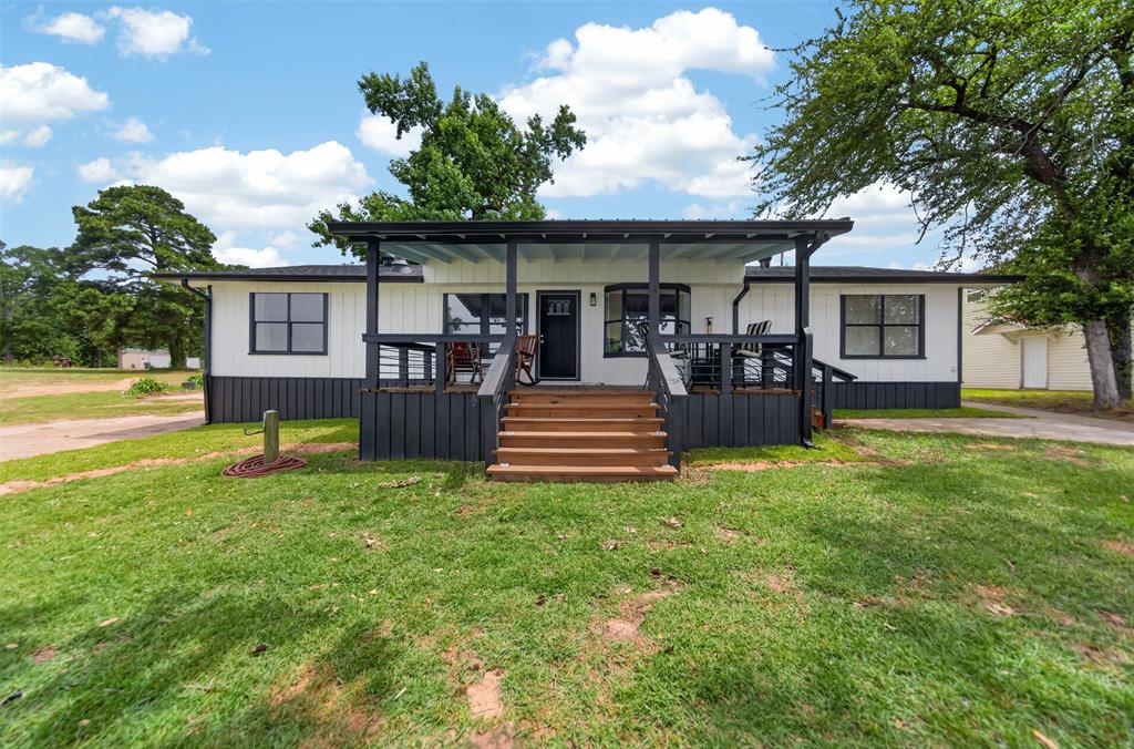 23363 Wateridge Loop Flint, TX 75762 - Photo 17 of 40 a front view of house with yard and outdoor seating