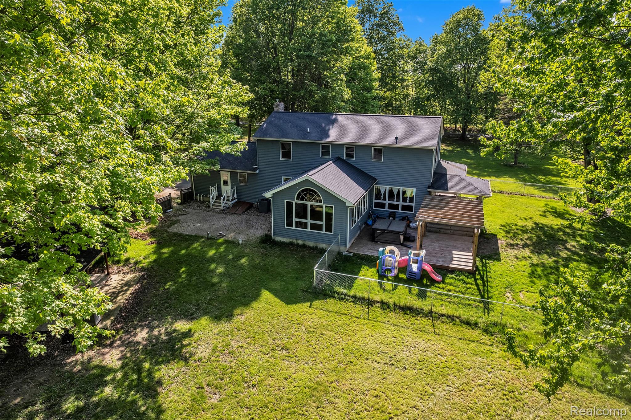 1345 Ives Road Mason, MI 48854 - Photo 84 of 92 Back of property with a fenced backyard and a chimney