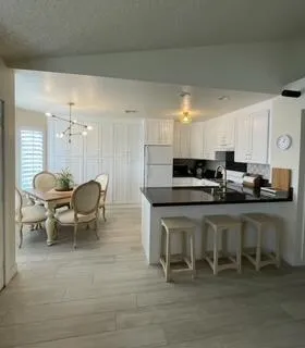 a open kitchen with a table and chairs in it