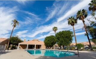 40880 Whirling Wind Drive, Unit C Palm Desert, CA 92211 - Photo 11 of 15 a view of a house with a yard and potted plants