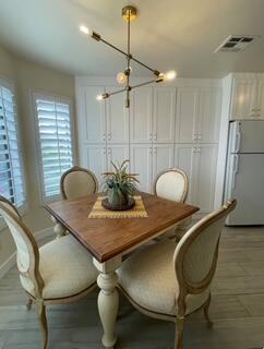 40880 Whirling Wind Drive, Unit C Palm Desert, CA 92211 - Photo 12 of 15 a dining room with furniture and window
