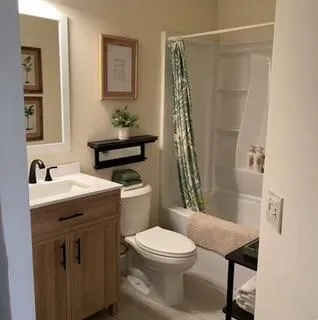 a bathroom with a sink toilet and shower