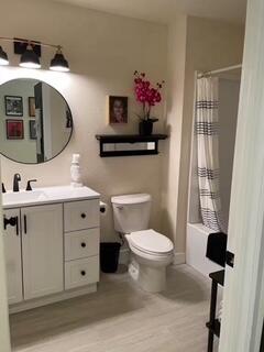 40880 Whirling Wind Drive, Unit C Palm Desert, CA 92211 - Photo 8 of 15 a bathroom with a sink mirror and toilet