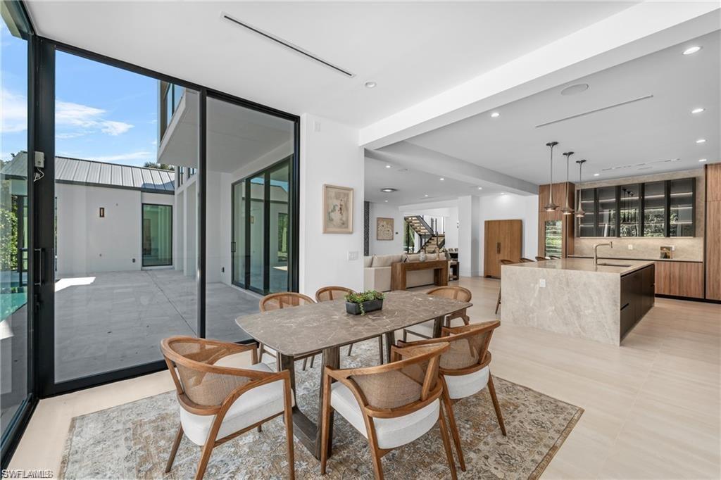 1800 Crayton Road Naples, FL 34102 - Photo 12 of 32 Dining space with floor to ceiling windows and recessed lighting
