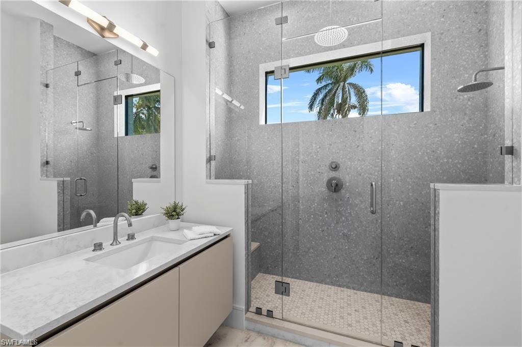 1800 Crayton Road Naples, FL 34102 - Photo 20 of 32 Bathroom featuring vanity and a stall shower