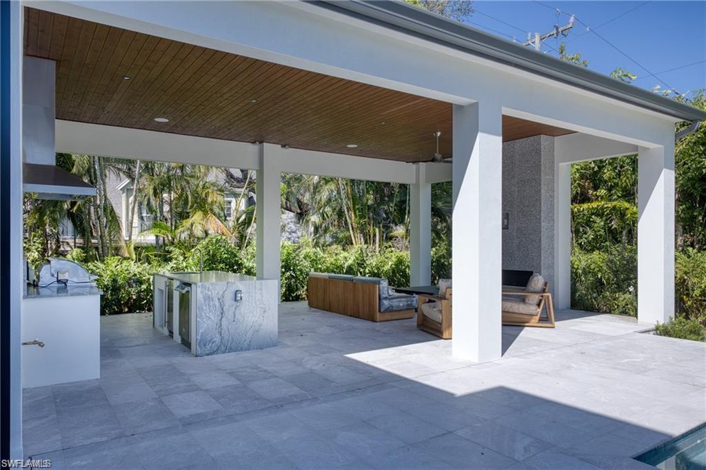 1800 Crayton Road Naples, FL 34102 - Photo 29 of 32 View of patio featuring an outdoor kitchen and an outdoor living space