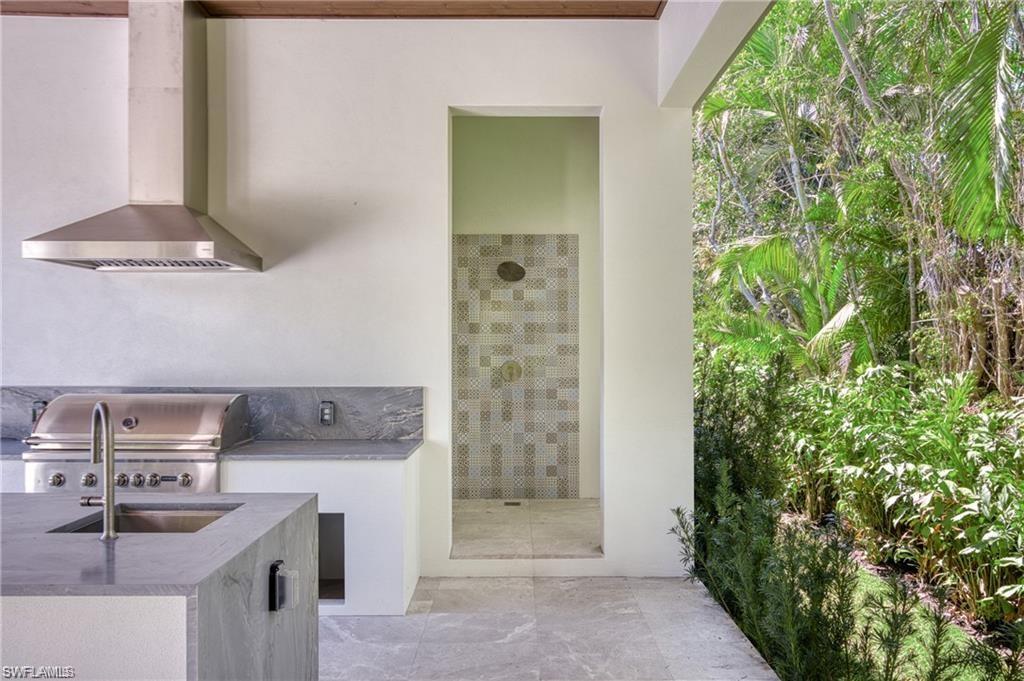 1800 Crayton Road Naples, FL 34102 - Photo 31 of 32 View of patio with an outdoor kitchen and a sink