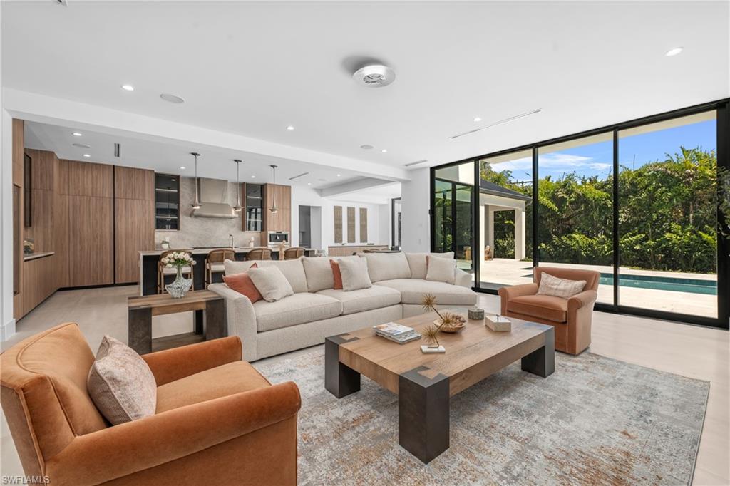 1800 Crayton Road Naples, FL 34102 - Photo 6 of 32 Living room with a wall of windows and recessed lighting