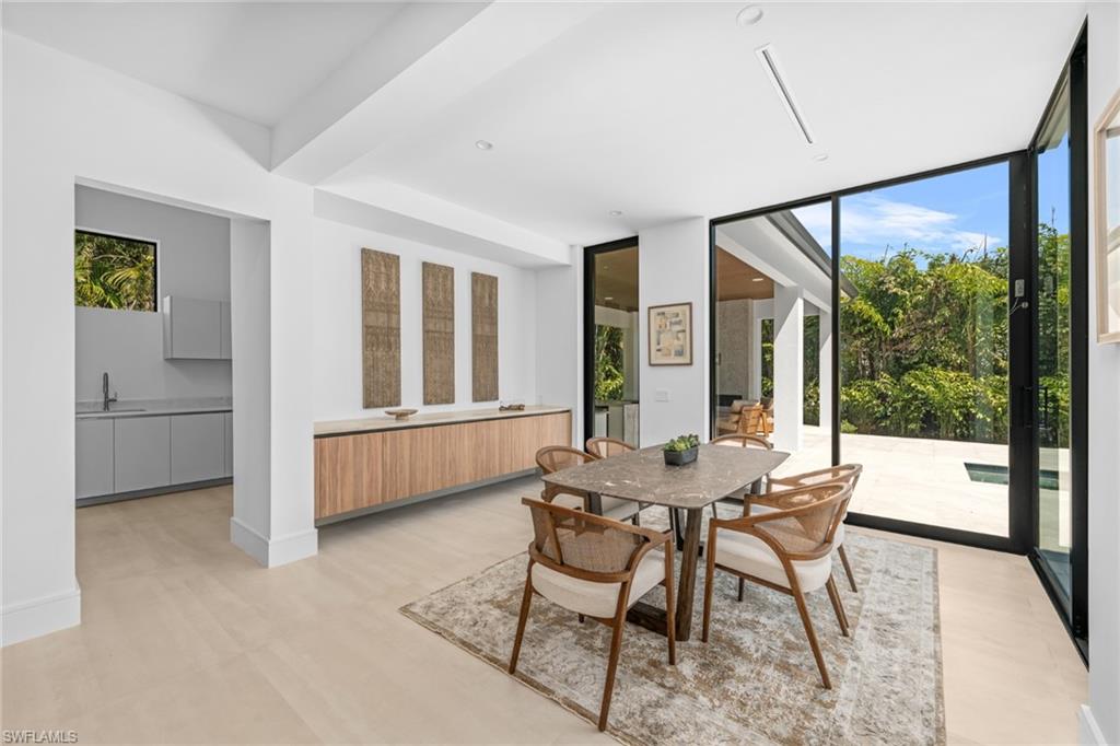 1800 Crayton Road Naples, FL 34102 - Photo 10 of 32 Dining room with healthy amount of natural light and floor to ceiling windows