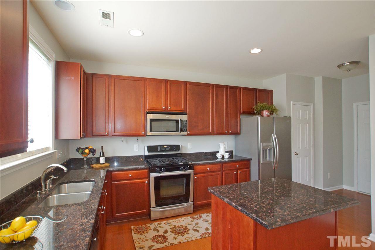 509 Front Ridge Drive Cary, NC 27519 - Photo 15 of 30 a kitchen with stainless steel appliances granite countertop a stove a sink dishwasher a refrigerator and a microwave