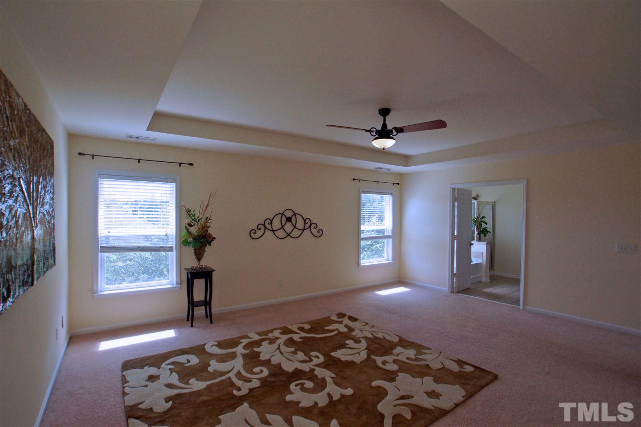509 Front Ridge Drive Cary, NC 27519 - Photo 17 of 30 a bedroom with natural light and hardwood