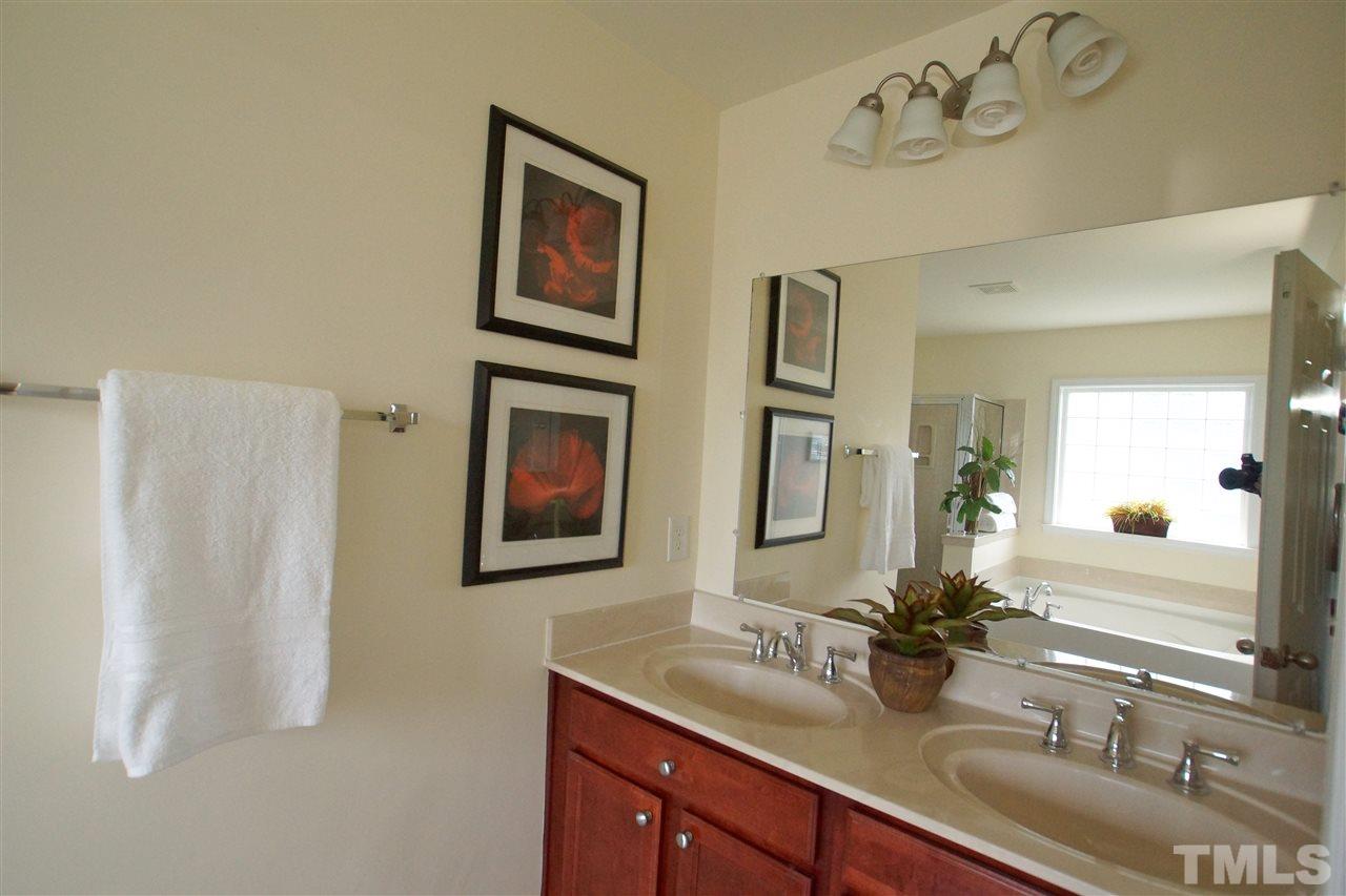 509 Front Ridge Drive Cary, NC 27519 - Photo 19 of 30 a bathroom with a double vanity sink and a mirror