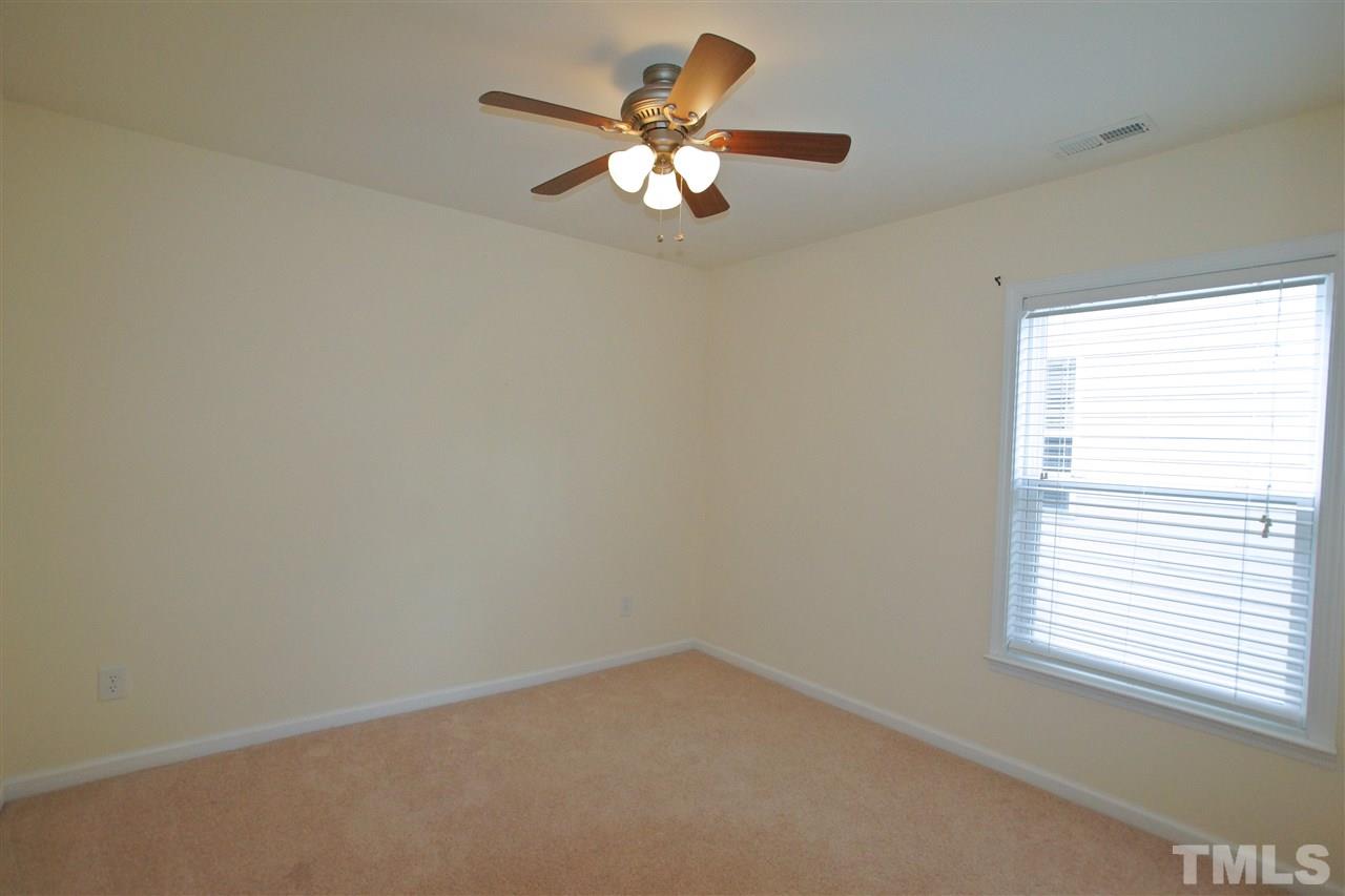 509 Front Ridge Drive Cary, NC 27519 - Photo 24 of 30 an empty room with a window and a fan