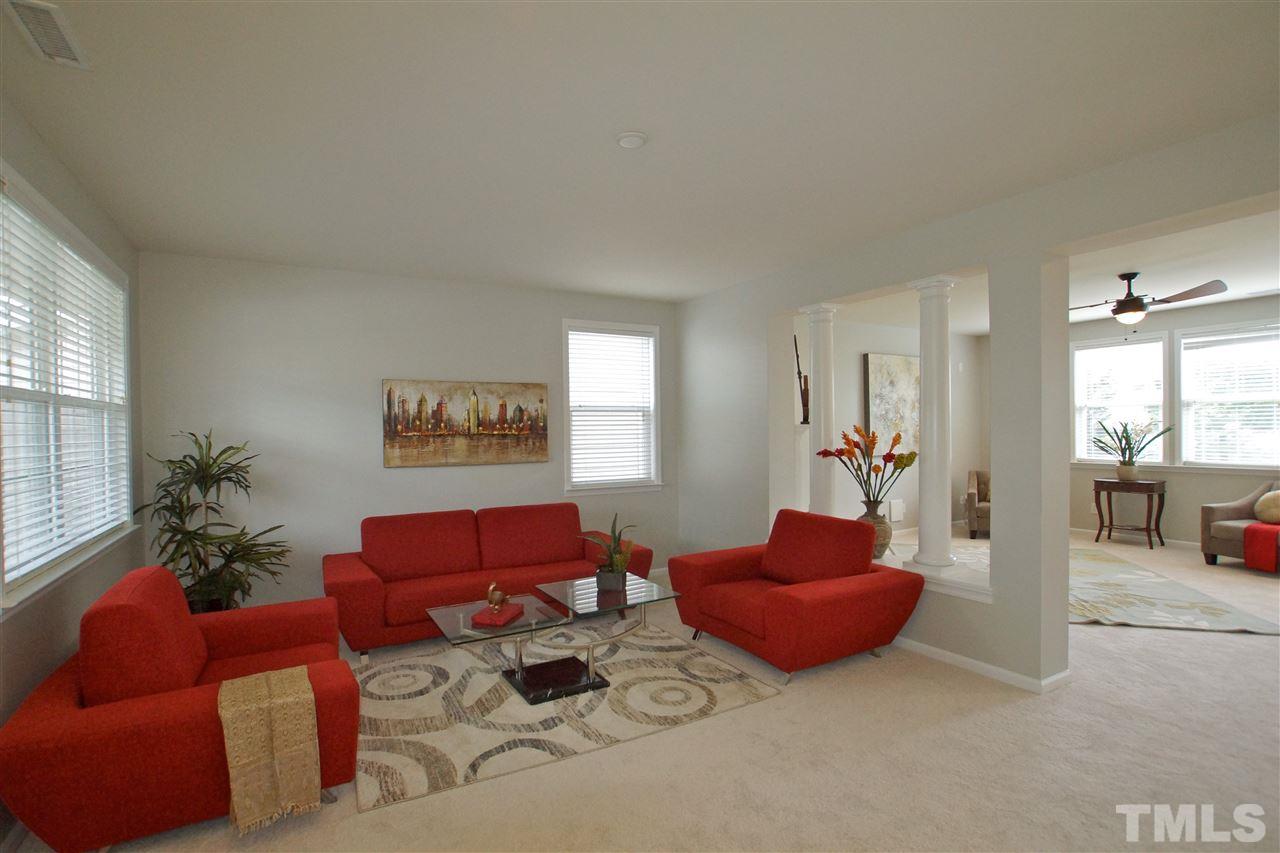 509 Front Ridge Drive Cary, NC 27519 - Photo 5 of 30 a living room with furniture a couch and a potted plant