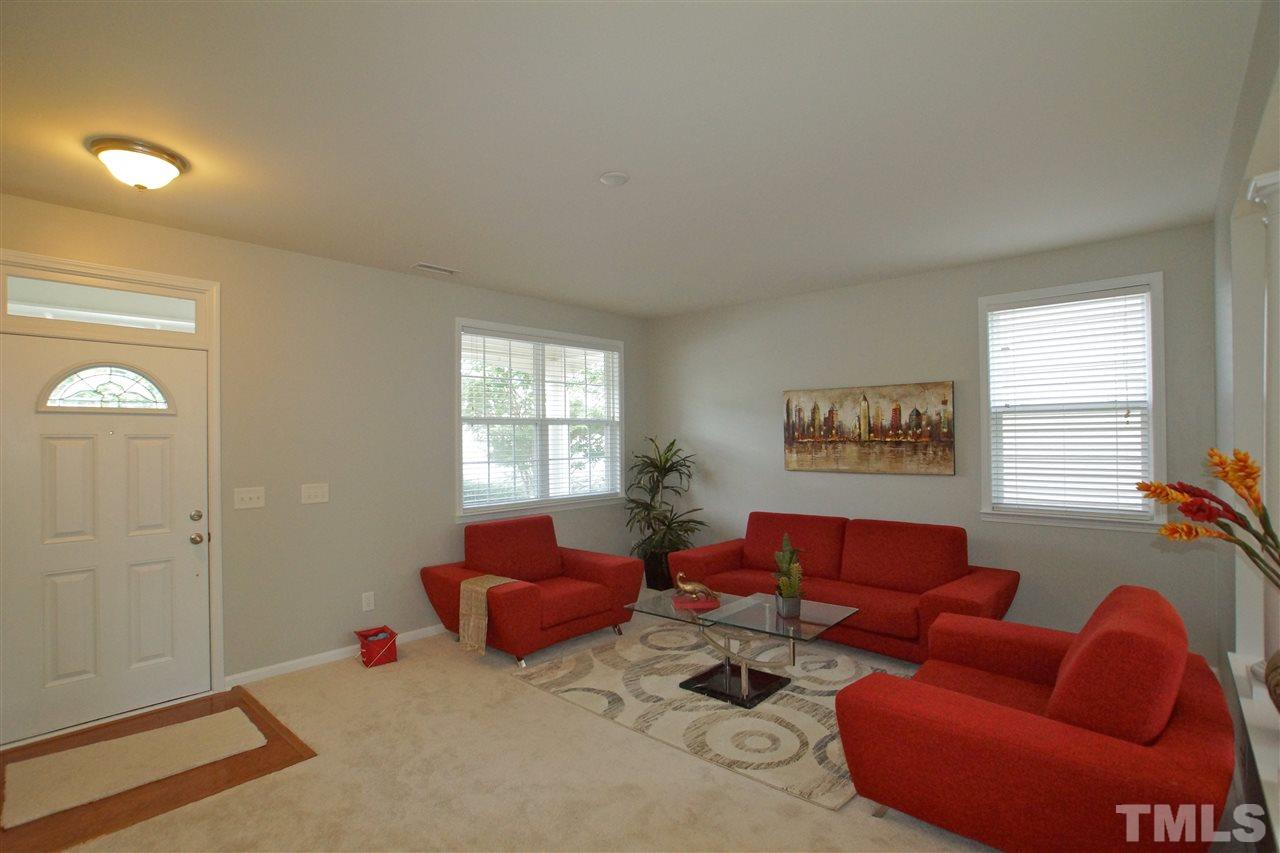 509 Front Ridge Drive Cary, NC 27519 - Photo 7 of 30 a living room with furniture a couch and a window