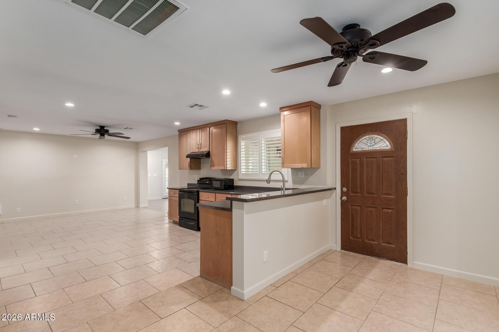 1628 East Del Rio Drive Tempe, AZ 85282 - Photo 6 of 32 a kitchen with stainless steel appliances granite countertop a refrigerator a sink and a stove