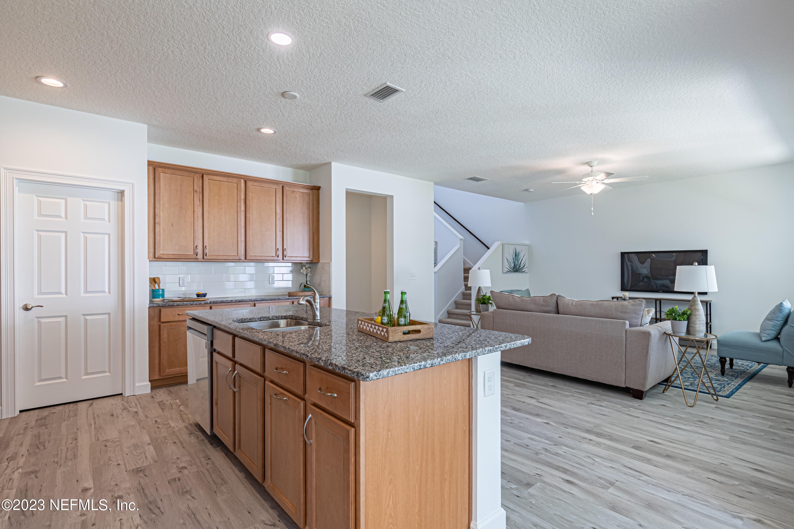 3093 Orange Picker Road Jacksonville, FL 32223 - Photo 16 of 39 a kitchen with stainless steel appliances granite countertop a sink stove and wooden floor