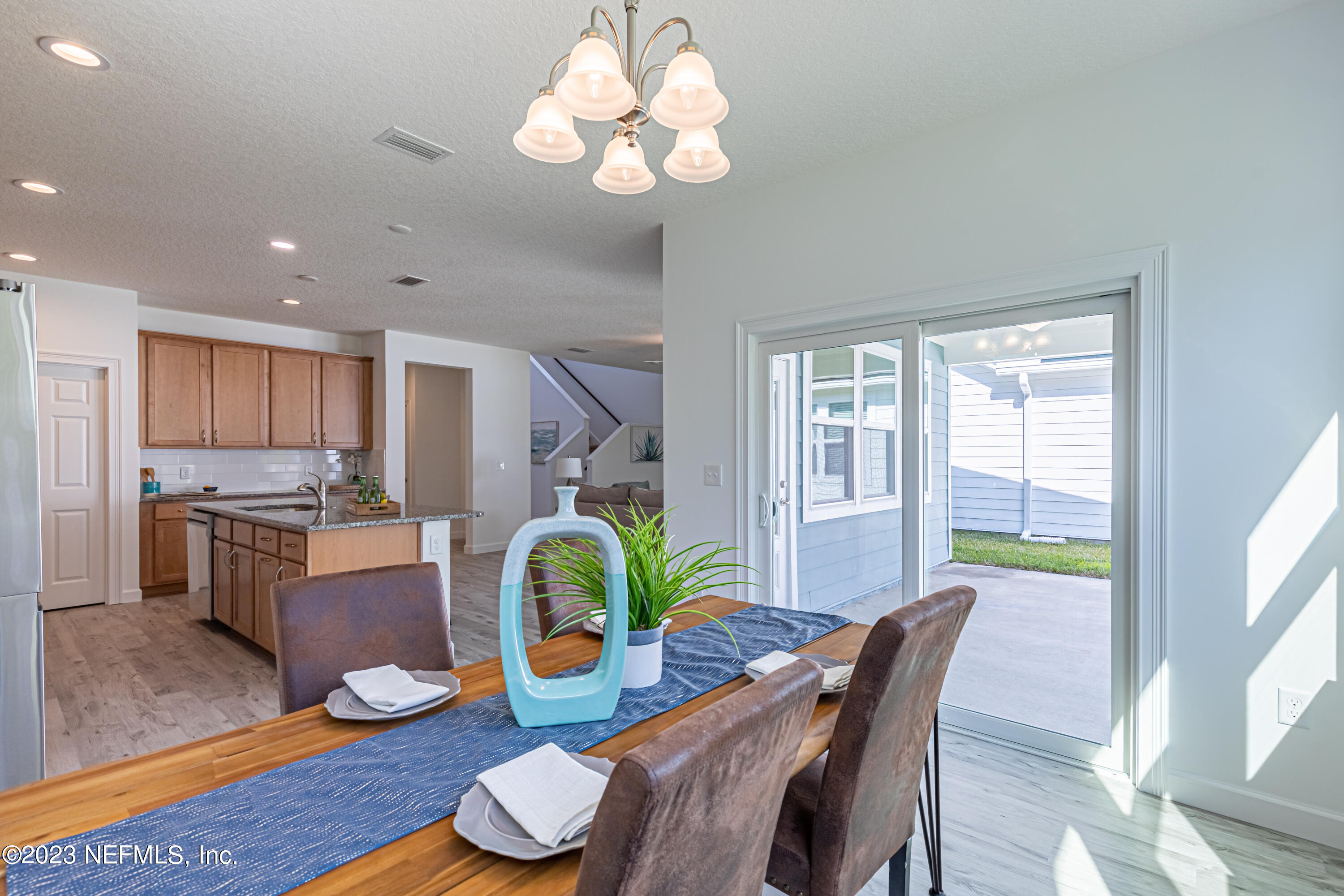 3093 Orange Picker Road Jacksonville, FL 32223 - Photo 19 of 39 a dining room with wooden floor and chandelier