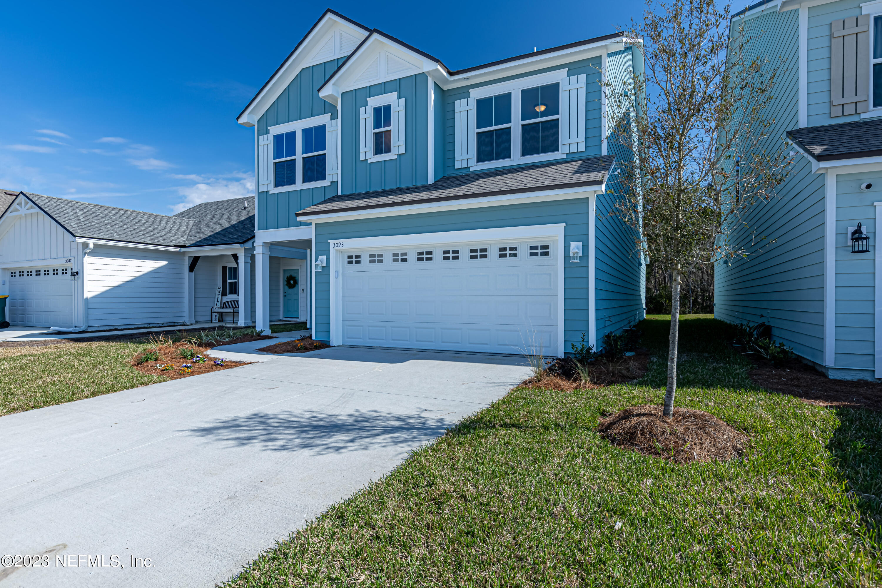 3093 Orange Picker Road Jacksonville, FL 32223 - Photo 2 of 39 a front view of a house with a yard and garage