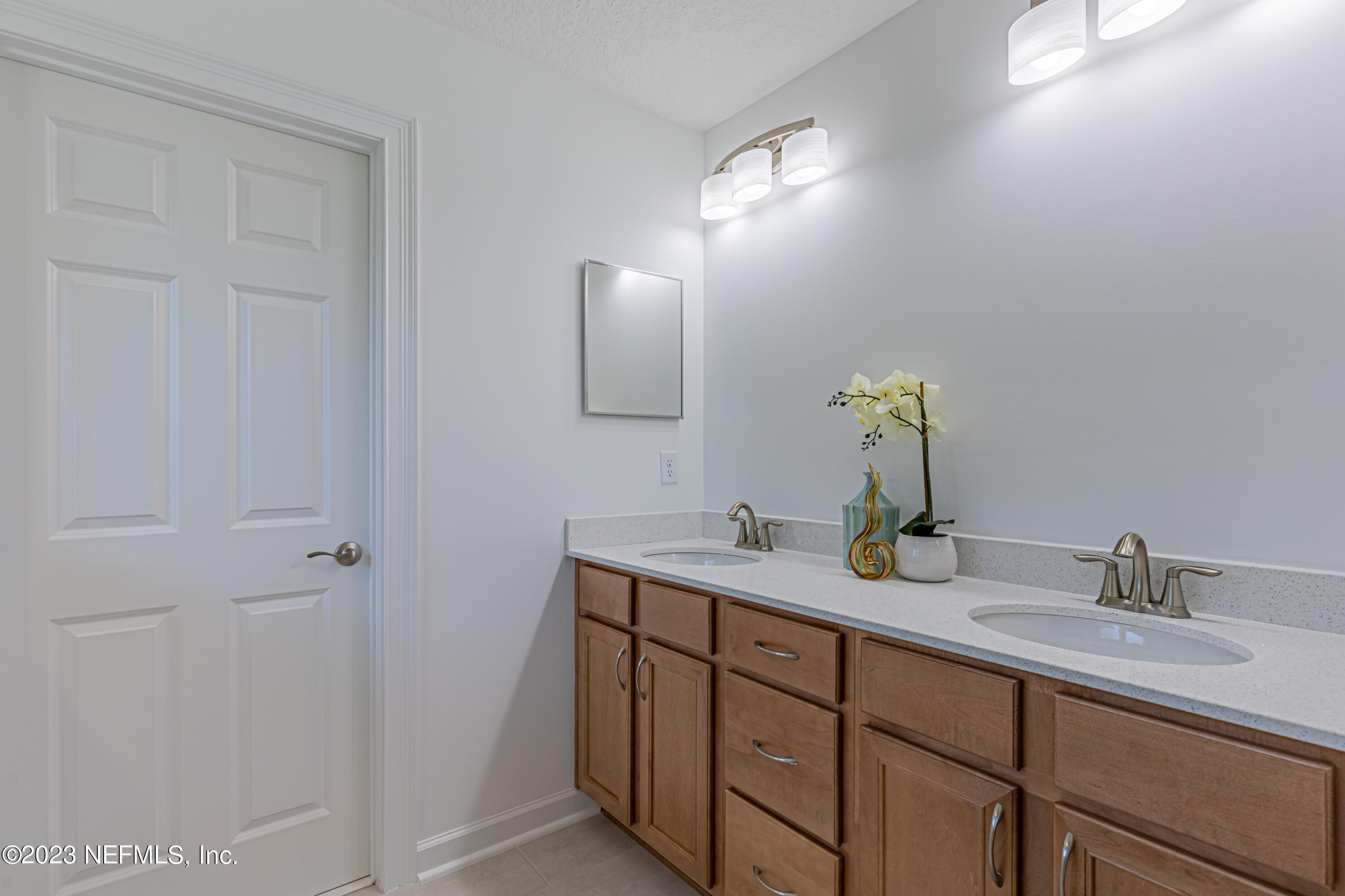 3093 Orange Picker Road Jacksonville, FL 32223 - Photo 27 of 39 a bathroom with a granite countertop sink and a mirror