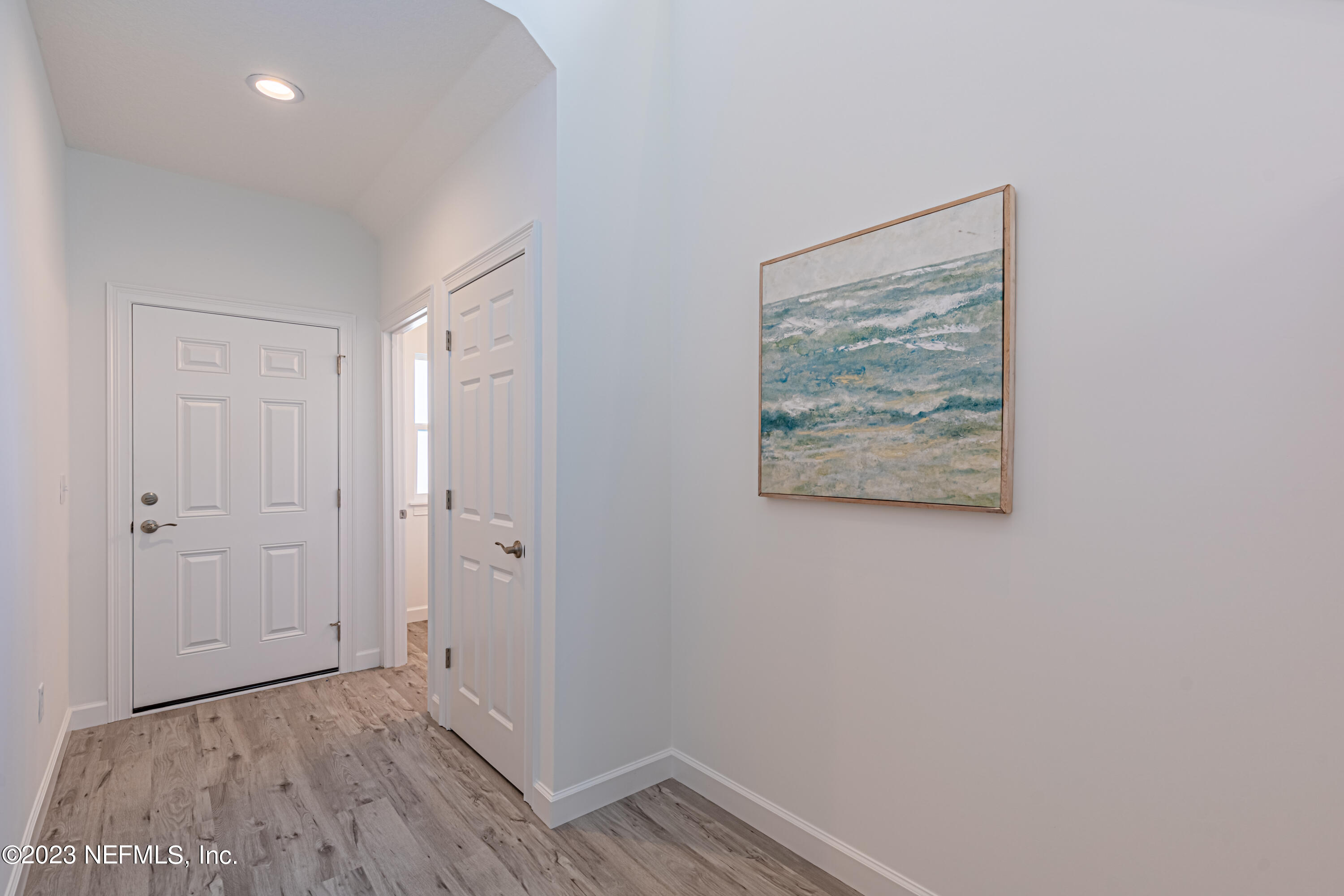3093 Orange Picker Road Jacksonville, FL 32223 - Photo 3 of 39 a view of a hallway with wooden floor